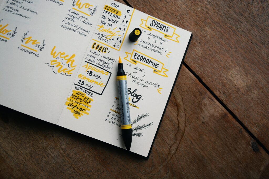 bullet journal with highlighter and marker writing